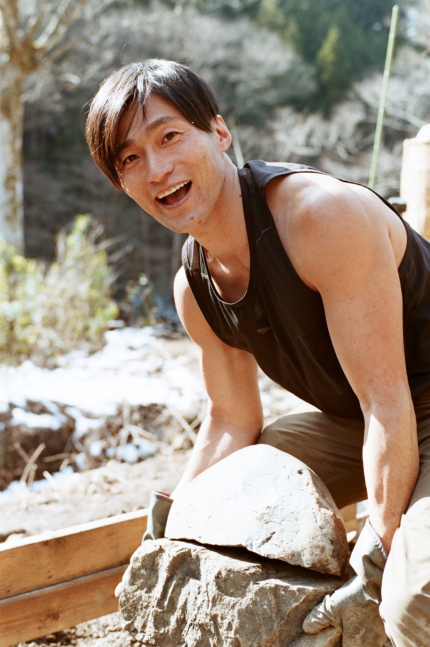 Tacchan building stone walls in the wasabi fields of Okutama