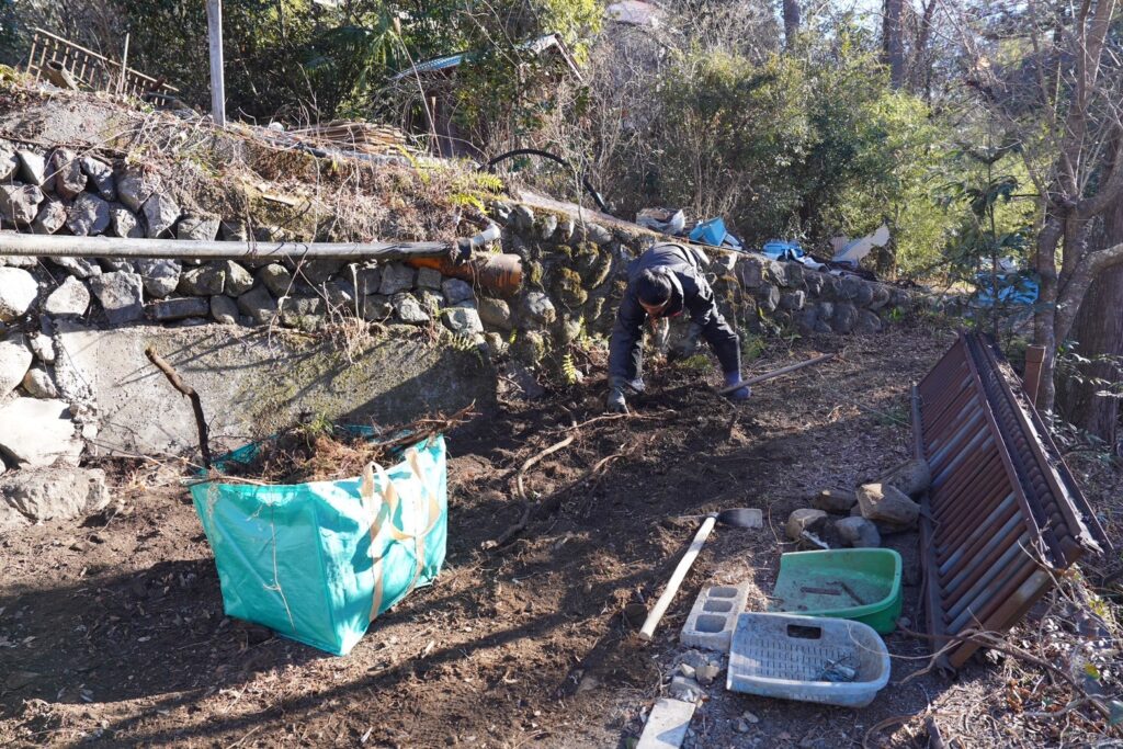 Farmer rebuilding the stone walls of a typhoon-damaged wasabi bed in the Okutama mountains
